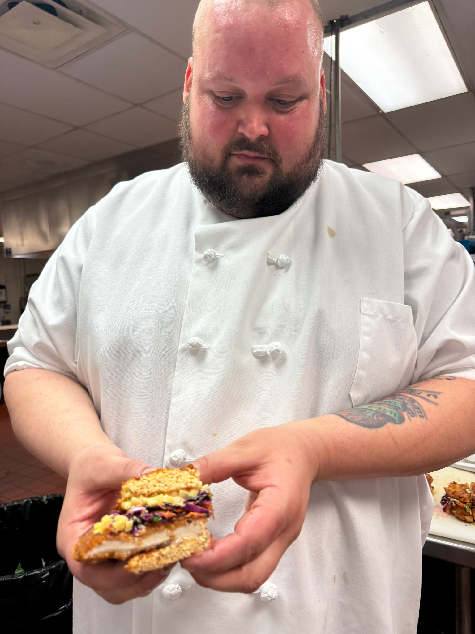 A member of The Grove KC community preparing food in a kitchen.